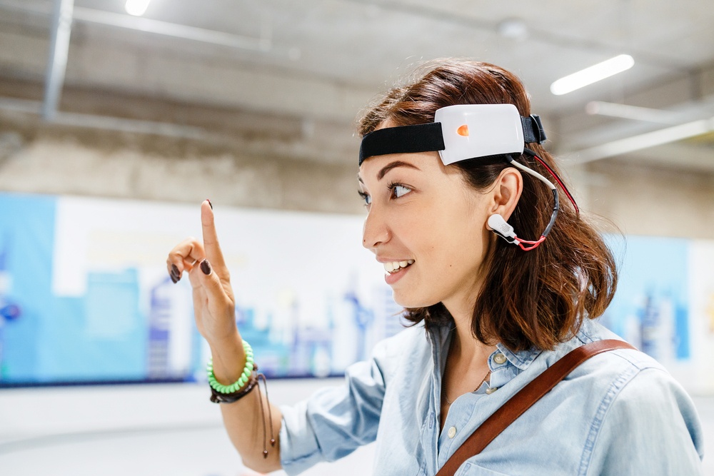 Woman,With,Digital,Headset,Sensor,Connected,To,Her,Ear,,Reading