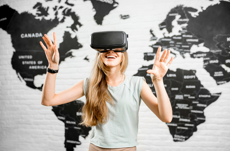 Young,Woman,Using,Virtual,Reality,Glasses,Sitting,Indoors,With,World
