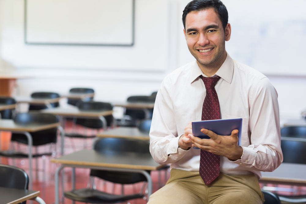 Portrait,Of,A,Smiling,Teacher,With,Tablet,Pc,In,The