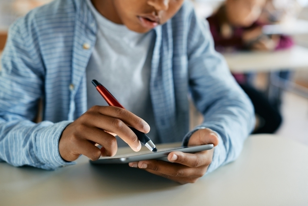 Close-up,Of,African,American,Elementary,Student,Using,Digital,Tablet,During